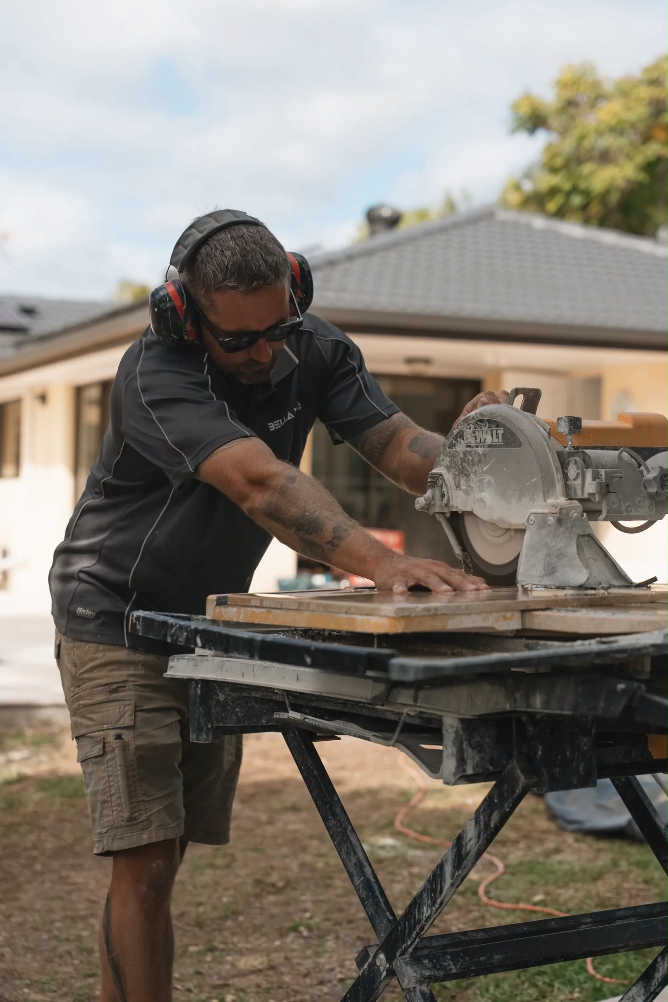 Cutting a stone paver to size on a wet saw