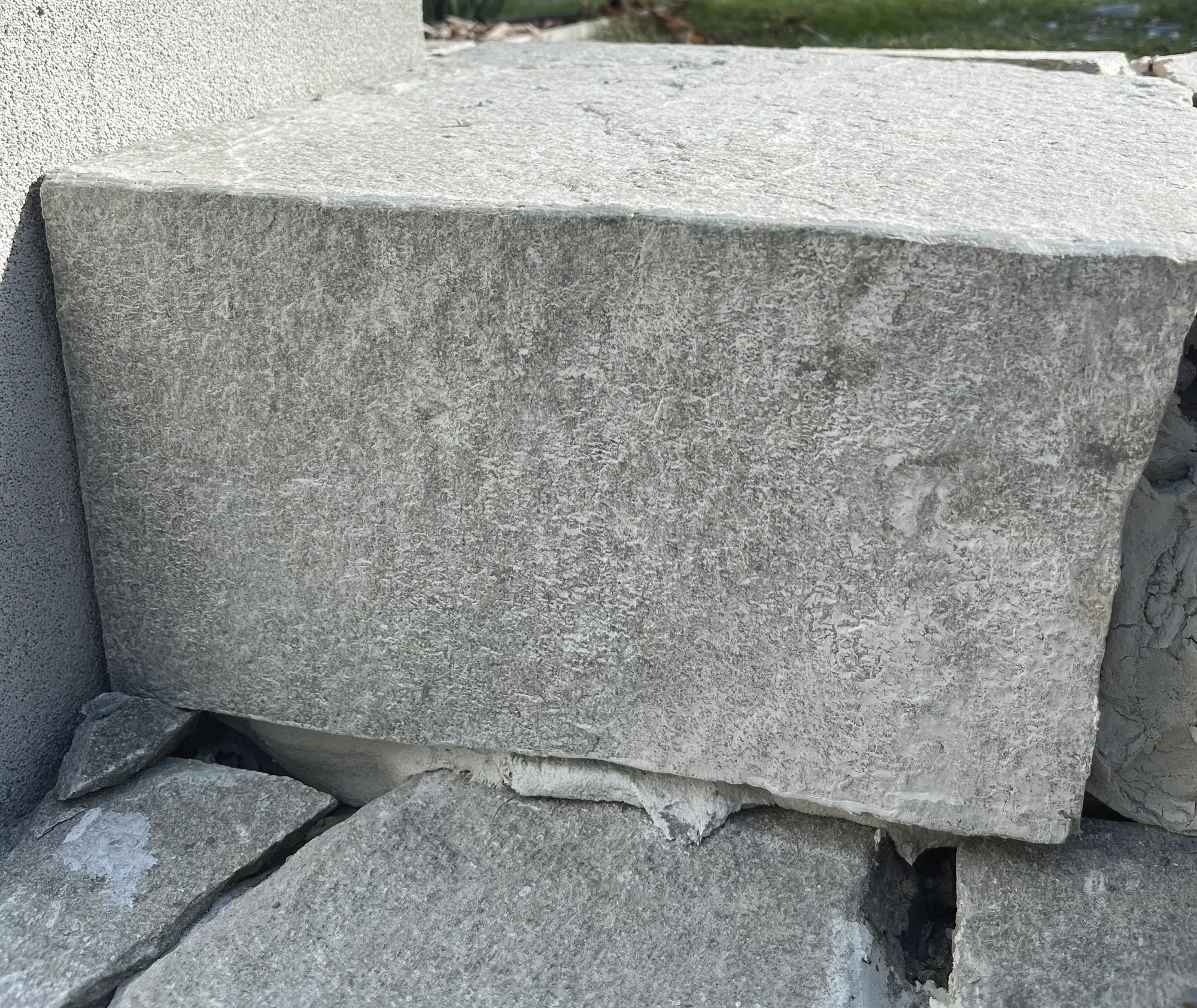 Close view of a sawn stone block set on rough split stone